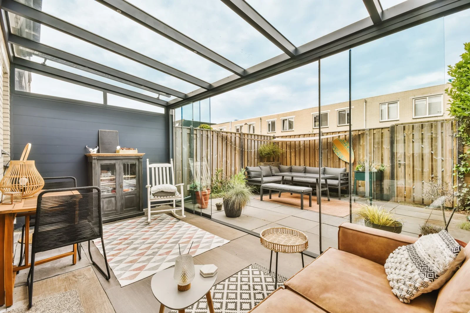 Glass veranda enclosing a contemporary patio seating area